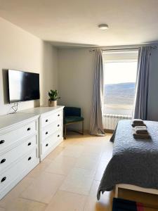 a bedroom with a dresser with a television on it at The View in Motovun