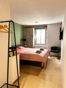 a bedroom with a bed and a chair and a window at The View in Motovun