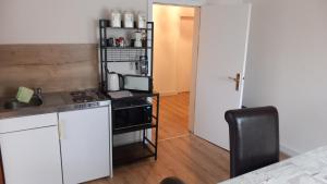 a small kitchen with a stove and a microwave at Werreufer 4ZKB 6 Einzelbetten in Detmold +6 photos