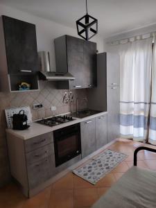 a kitchen with stainless steel cabinets and an oven at Casa Ventaglio Verde in Valledoria