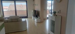 a living room with a couch and a tv at apartma Kiana in Šempeter pri Gorici