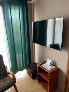 a living room with a flat screen tv on the wall at Apartamenty w Helu in Hel