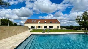 a house with a swimming pool in front of a house at L'Echo du Bonheur in Vaumas