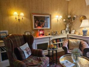 a living room with two chairs and a fireplace at The Casterbridge in Dorchester