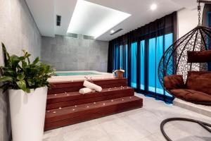 a bathroom with a soaking tub and a swing at Hotel Nestos in Omiš