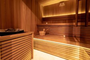 a sauna with a tub and a sink in a room at Hotel Nestos in Omiš