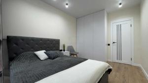a bedroom with a large bed with a black headboard at Apartment in Irpin Pavlenka in Irpin