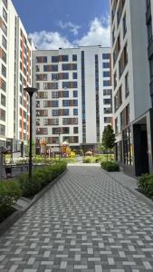 a cobblestone street in a city with tall buildings at Apartment in Irpin Pavlenka in Irpin