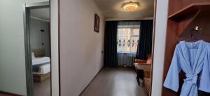 a room with a bedroom with a bed and a mirror at Ayanchin Hotel in Ulaanbaatar +71 photos