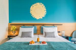 a hotel room with a bed with a tray of fruit on it at Hotel Nestos in Omiš