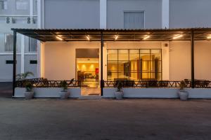 a building with a balcony with potted plants at MAXONE Batam in Nagoya
