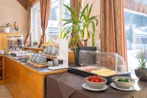 a buffet with bowls of food on a table at Apartmentdorf Flößerstube in Grossraming
