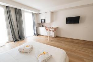 a white bedroom with a bed with two pillows at City Boutique in Porto Torres