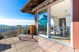 a balcony with a view of the ocean at Hostdomus - Residenza La Vigna in Dogliani