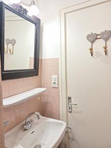 a bathroom with a sink and a mirror and a shower at Le Ptit Beau Jus in Aillon-le-Jeune