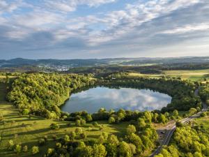 an aerial view of a lake in the countryside at Ferienanlage Villa Maare in Gillenfeld