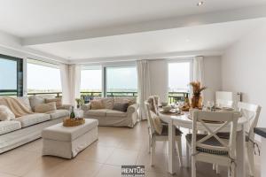 a living room with a table and a dining room at Seange - with beautiful view and many facilities in Nieuwpoort