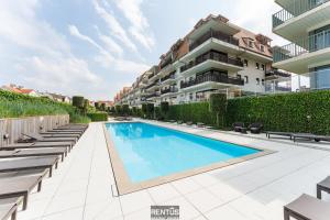 an image of a swimming pool in a building at Seange - with beautiful view and many facilities in Nieuwpoort