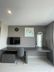 a desk with a chair in a room at Golden Bay Danang in Danang