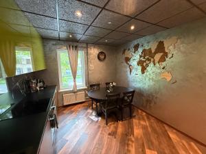 a dining room with a table and a room with a map on the wall at BRIVIBAS RESIDENCE - WAVE, free PRIVATE parking, free WIFI, self check-in in Riga