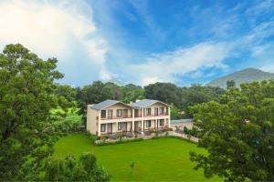 an aerial view of a large house with a large yard at Milestone Resort in Thūr
