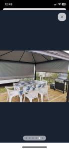 a picture of a table and chairs under a tent at Lux in Saint-Pierre-dʼOléron