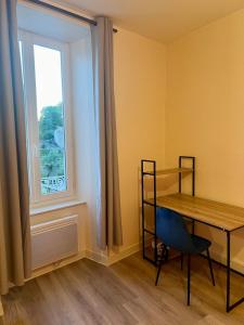 a room with a table and a window at Maison de la Gour MELLE in Melle +4 photos