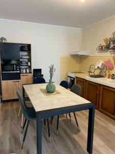 a kitchen with a table and chairs in a room at Maison de la Gour MELLE in Melle