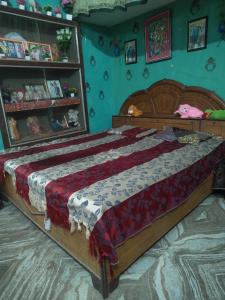 a bedroom with a large bed in a room at Dheeraj Kumar Homestay in Phalauda