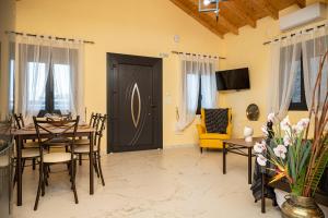 a dining room with a table and a yellow chair at Sirius House in Mytilinioí +22 photos