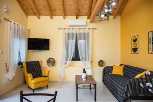 a living room with a couch and a chair at Sirius House in Mytilinioí