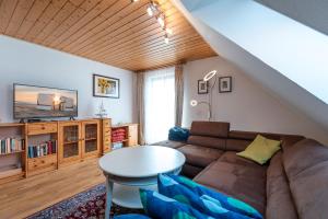 a living room with a couch and a table at Ferienhaus MeerGenerationen in Ueckeritz