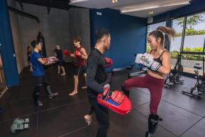 a group of people in a gym with a woman holding a box at HOMA Phuket Town in Phuket +146 photos