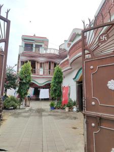 a large pink building on a street at Dheeraj Kumar Homestay in Phalauda