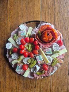 a plate of food with vegetables on a table at Love Room La Crèche Romantique in Bogny Sur Meuse