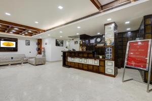 a large room with a store with a clock on the wall at Arch The Venus - Free Airport Pickup or Drop in New Delhi