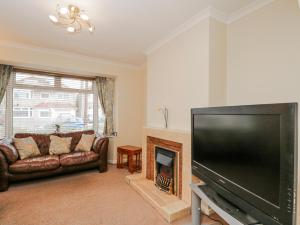 a living room with a large flat screen tv at Lavender Harmony House in Swindon