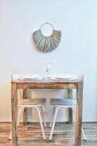 a wooden table with a mirror and a chair at Sotto Terra in Katwijk aan Zee