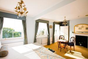 a bedroom with a bed and a table and chairs at Pier View Self Catering Luxury Apartments in Southend-on-Sea +120 photos