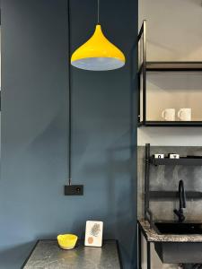 a yellow light hanging over a kitchen counter at Smile Residence Bishkek in Bishkek