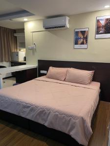 a bedroom with a large bed with a air conditioner on the wall at Crystal Studio Apartment KBCP in Kota Bharu +37 photos
