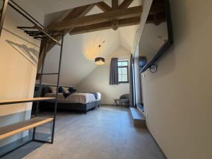 a large room with a bed and a room with a bed sqor at Le Fourquet Blaugies - Hôtel & restaurant in Dour