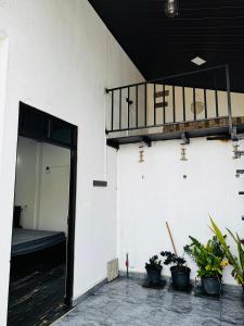 an open door of a building with potted plants at 22 apartments in Kalapaluwawa