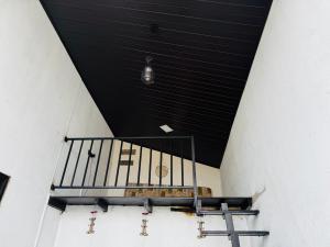 a room with a black ceiling and a table at 22 apartments in Kalapaluwawa +2 photos