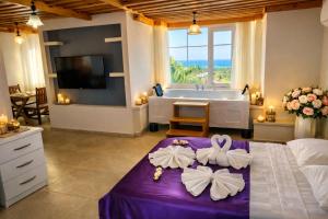 a bathroom with a tub and a bed with bows at Patara Evleri in Patara +73 photos