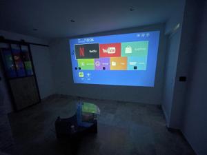 a room with a large screen in a dark room at The13th in Rueil-Malmaison