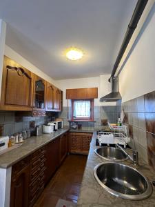a large kitchen with a sink and a stove at Cesira in Mareson +8 photos