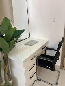 a desk with a chair and a laptop on it at ShowLove Luxury Apartment in Lekki Phase 1
