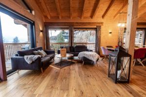 a living room with a couch and a table at Chalet Dinkel in Niedernsill in Niedernsill