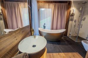 a bathroom with a large tub and a sink at Chalet Dinkel in Niedernsill in Niedernsill